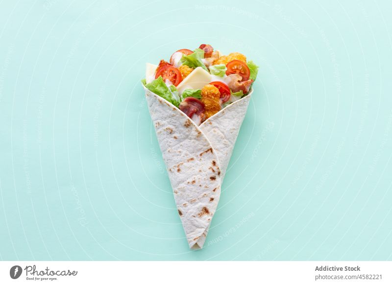 Chicken wrap with tomatoes and cheese chicken tortilla food lettuce snack meal fast food tasty delicious fresh vegetable nutrition colorful appetizing product
