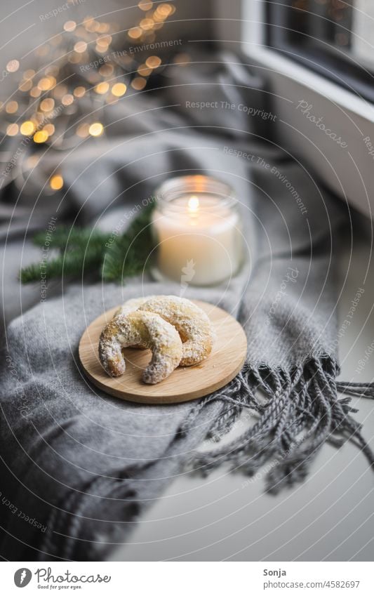 Vanilla cookies on a plate and a candle on a window sill. Christmas & Advent shoulder stand Window board Still Life hygge homemade Dessert Light Flame