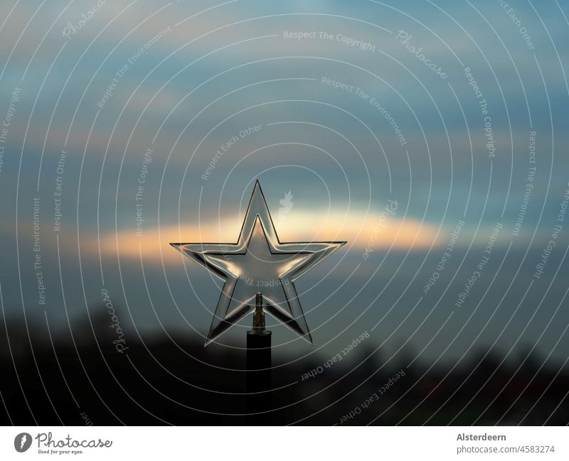 Five pointed star on a staff with blue sky and setting sun in background Stars five pronged Blue sky Evening sun Beautiful weather Sky Nature Clouds