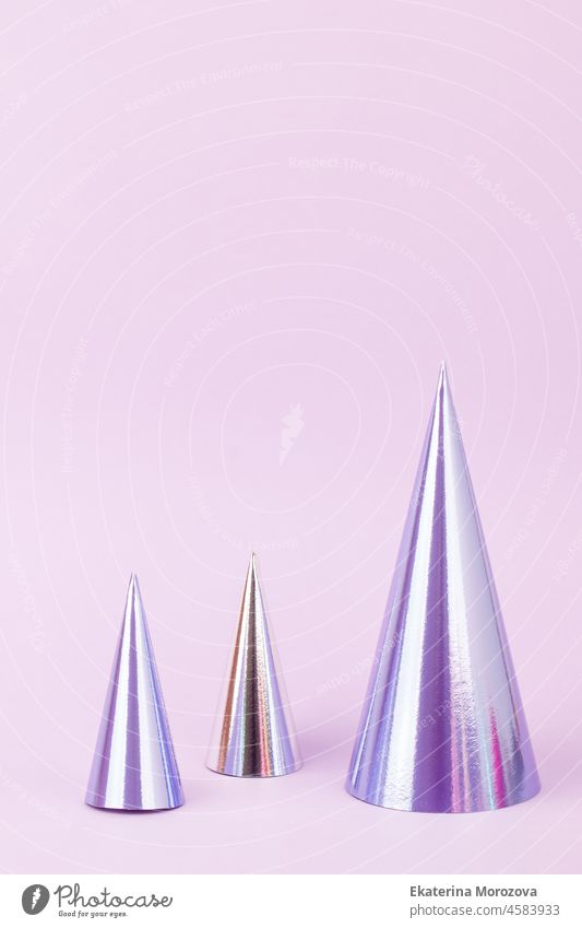 Futuristic modern abstract Happy New Year 2022, Merry Chrstmas concept. Christmas tree made of hologram paper on pastel purple background, copy space, banner for your website, invitation, flyer
