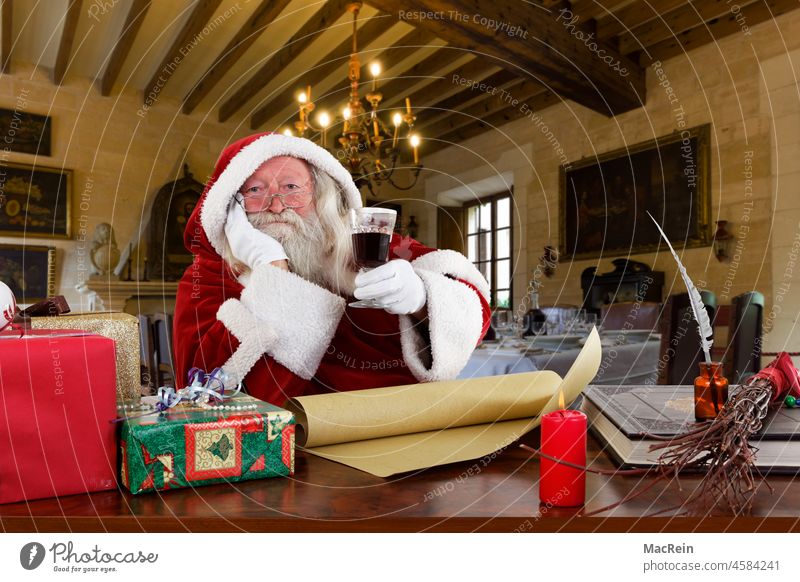 Santa Claus with a glass of red wine in his hand Age 83 years masculine Facial hair Book a person Human being Single person single human European ancestry