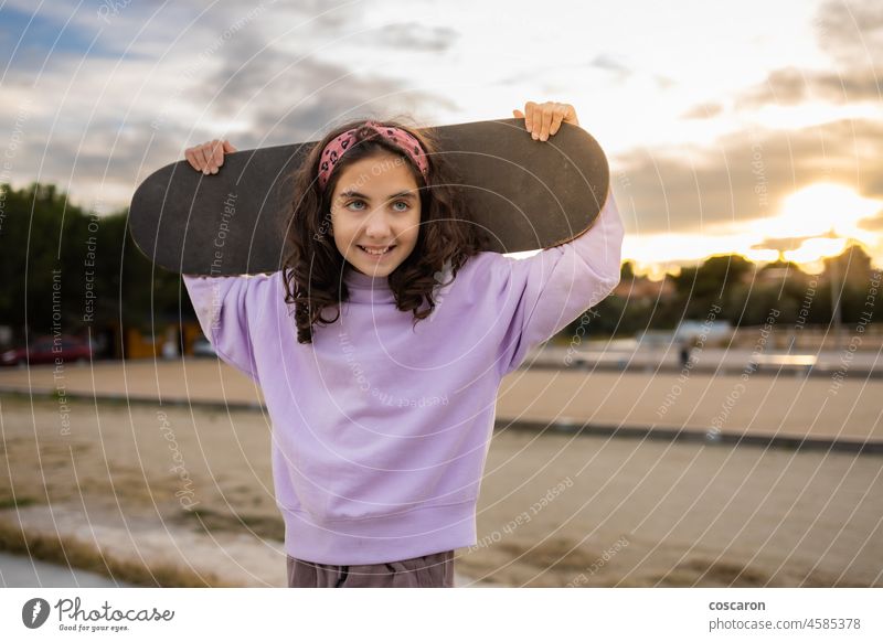 Little girl having fun with a skate board active activity beautiful caucasian child cool cute enjoy fashion female happy hipster hobby leisure lifestyle