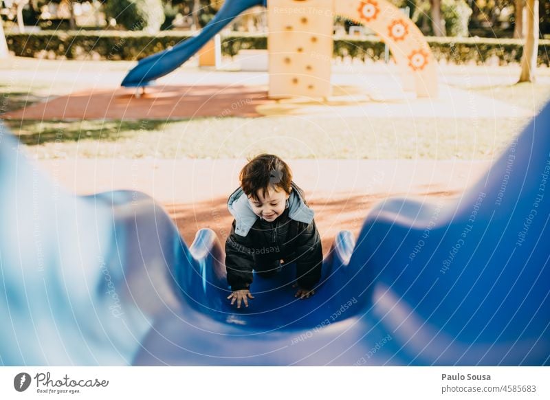 Child playing in the playground Boy (child) Slide Playground Playing playground equipment 1 - 3 years boy Caucasian having fun Park Leisure and hobbies Happy