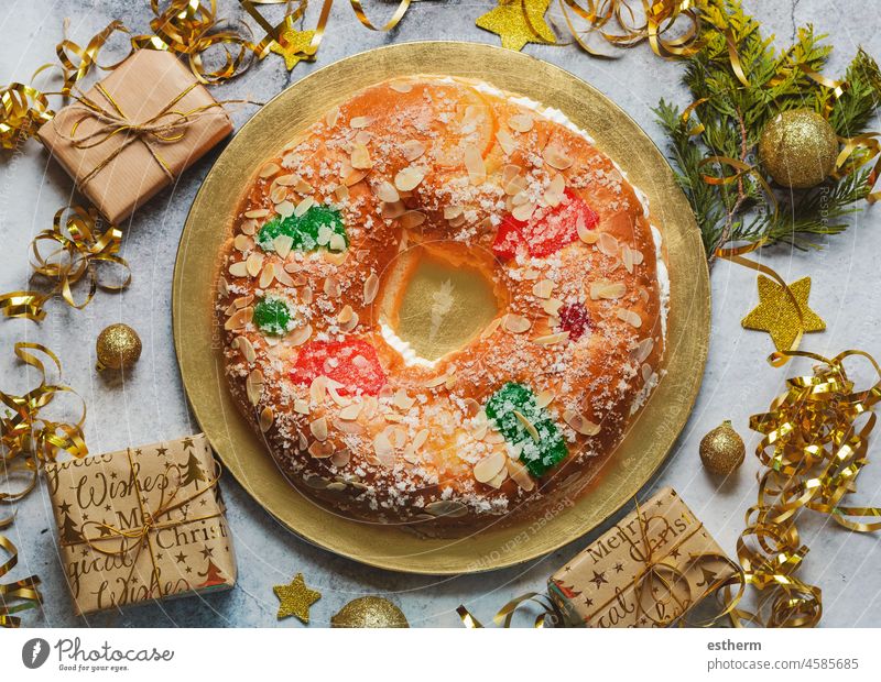 Roscon de reyes with cream and christmas ornaments. Kings day concept spanish three kings cake.Typical spanish dessert for Christmas christmas dessert