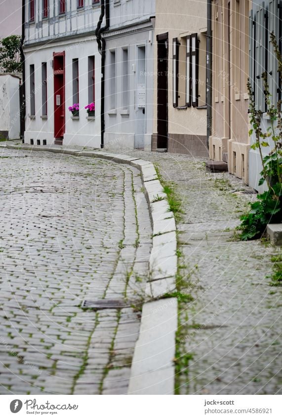 along the curb through empty streets Cobblestones Old town Street Facade Brandenburg an der Havel Architecture Past Authentic Curbside slanting Lanes & trails