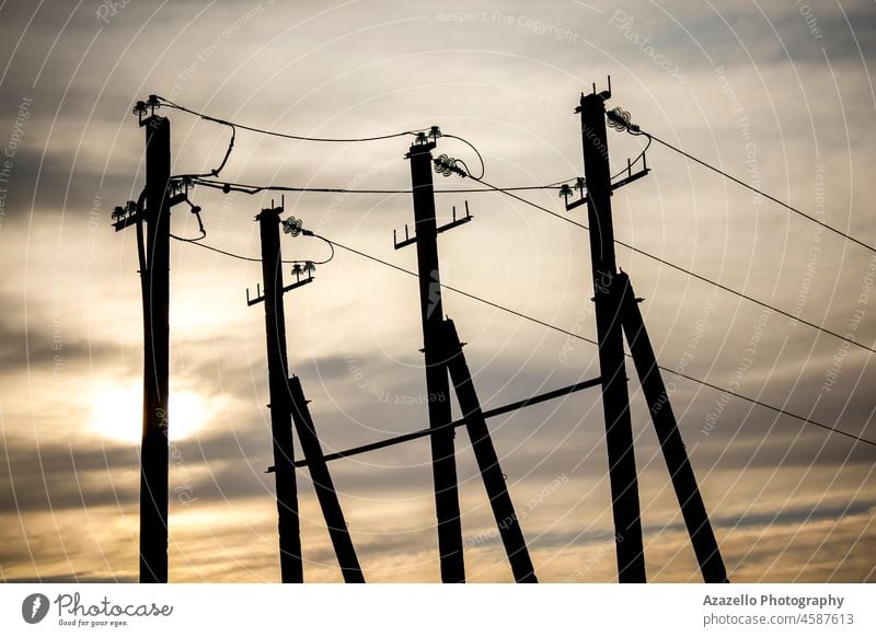 Electricity transmission pylon view against the sky during sunset. geometry direction cable wire power supply station distribution beauty natural nature eco