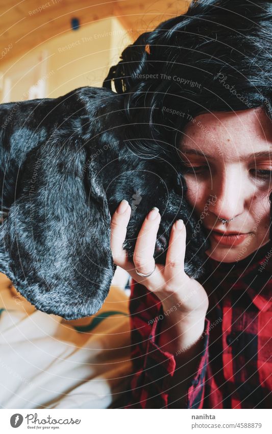 Cute shot of a young woman spending time with her dog pet love family care adorable loving home together togetherness brunette cocker cocker spaniel animal