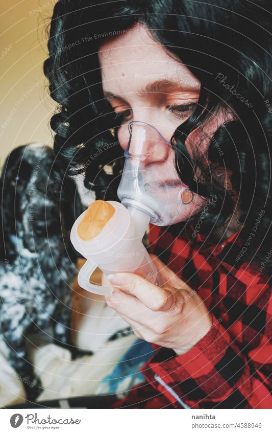 Young woman wearing an oxygen mask medical asthma flu allergy covid coronavirus covid-19 breathe ill illness healthcare young brunette close close up equipment
