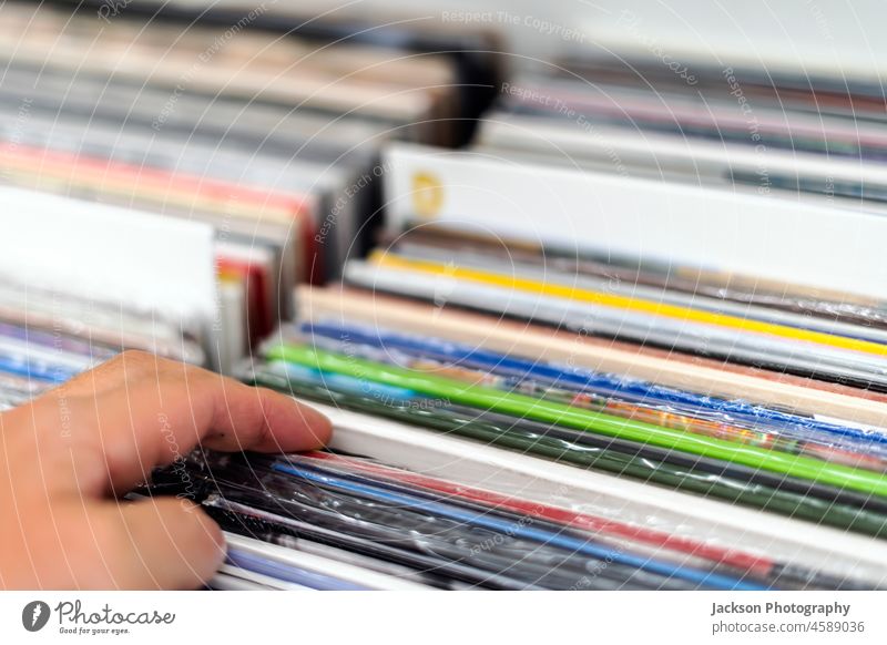 Choosing the vinyl album in the vinyl record shop choose closeup vinyl records bunch turntable flea hand gramophone used retail adult picking lifestyle analog