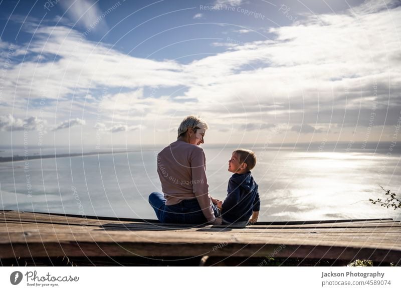 Mother and 3 years old son hugging each other and enjoying the beautiful ocean views, Portugal kid people child Child Boy (child) Infancy young Son