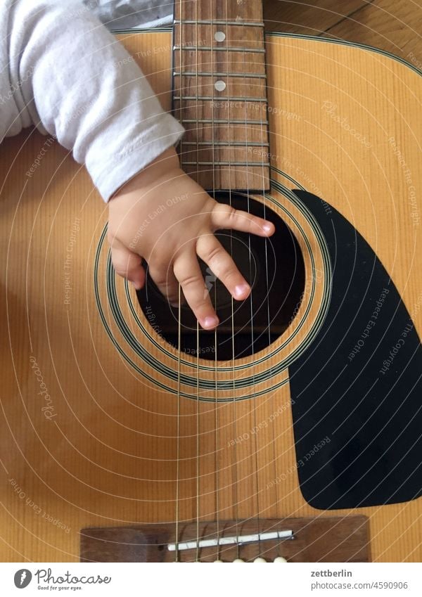 The baby plays the guitar very well Baby Child Toddler Hand Fingers Grasp Comprehend Guitar tool Music Musical instrument Musical instrument string