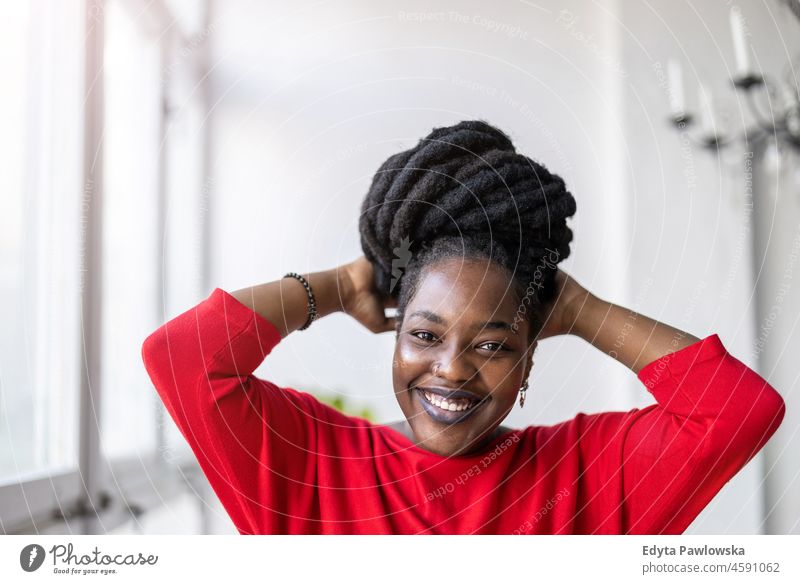 Portrait of a smiling young woman indoors black millennials hipster loft window natural adult one attractive successful people confident person beautiful female