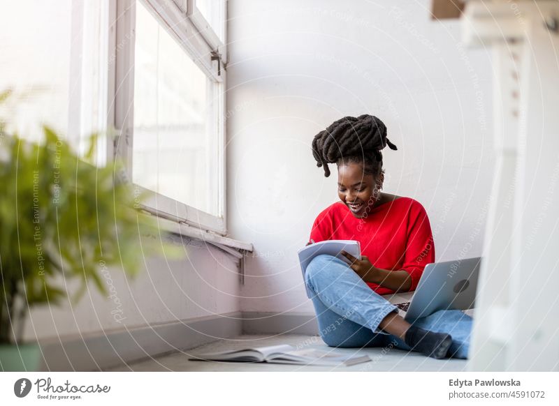 Female student studying at home black millennials hipster indoors loft window natural adult one attractive successful people confident person beautiful young