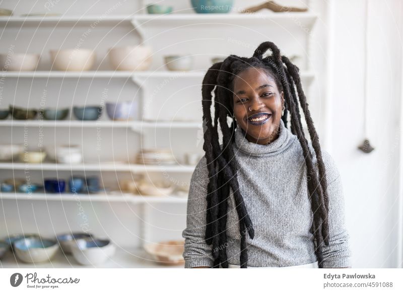 Confident female pottery artist in her art studio black millennials hipster indoors loft window natural adult one attractive successful people confident person