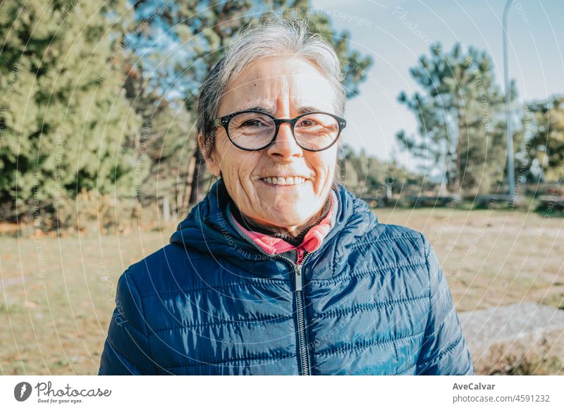 A senior old woman portrait smiling happy copy space.Starts new habits for the new year. Trekking and healthy life style.Pensioner woman sport. Aging, people, active lifestyle and health concept