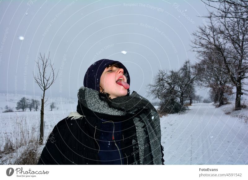 Catch the snowflake .... path fun snowfall tongue season nature scarf cap cold catches mouth road blue trees pathway Girl woman clothes black child snowflakes