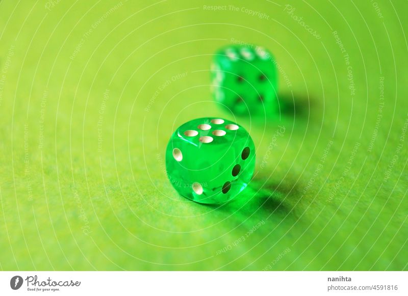 A vibrant monochromatic macro with depth of field about two green glass gambling dice with two lucky number six on green background. game bet monochrome