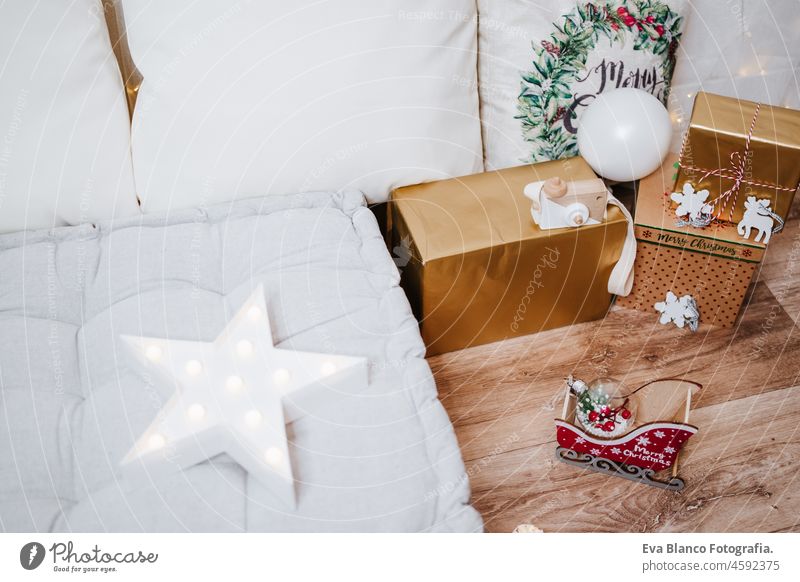 beautiful christmas decoration at home. Chimney, gifts, tree, noel, cushions on beautiful indoor white studio. Christmas concept. Nobody chimney evening bright