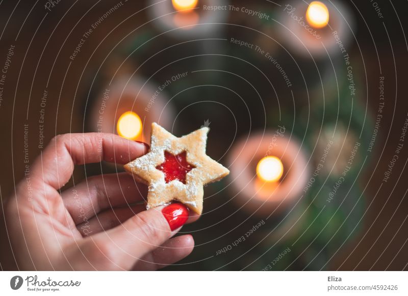 Hand holding Christmas cookies over Advent wreath Christmas wreath Christmassy Stars Cookie Christmas biscuit Christmas & Advent Candlelight candles rogues