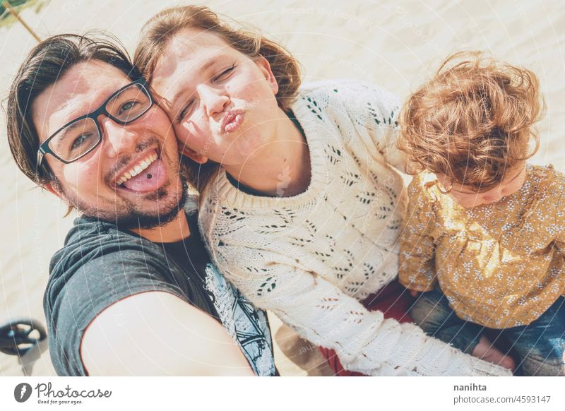 Young family posing together for a selfie in their holidays young happiness love baby parents parenthood smile smiling fun funny joy enjoy real candid life