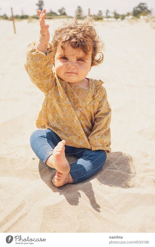 Little girl playing with sand at the beach baby motherhood vacation holidays outdoors sun kid toddler child enjoy warm fun funny portrait sunny warmth hoizon