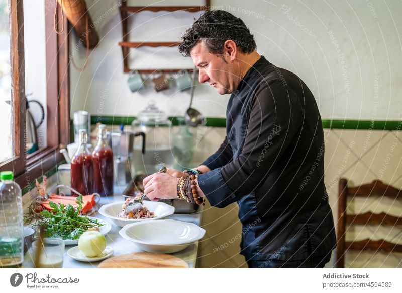 Man serving delicious food in kitchen man chef gastronomy professional restaurant assorted ingredient male serve tasty plate cook job prepare culinary dish