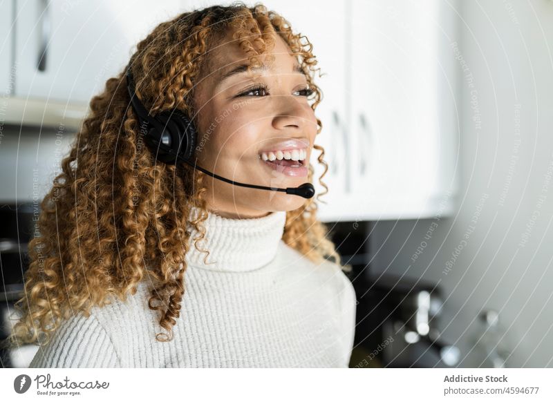 Happy black woman with headset haedset kitchen appearance smile positive music home female african american ethnic listen happy cheerful device gadget young