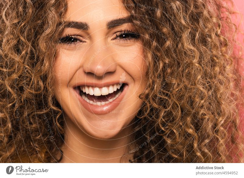 Smiling woman with curly hair smile happy cheerful positive optimist joy portrait glad appearance young delight toothy smile human face charming style
