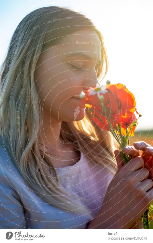 young woman with bouquet in poppy field Woman Bouquet sniff Poppy poppies sensual flowers fragrances daintily Young woman Poppy field wild flowers pretty Meadow
