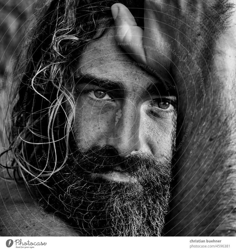 portrait of a long haired hippie with intense eyes Man long hairs 40 years Guru Intensive outstanding black and white Mystic Strong Hypnotic Robinson Crusoe
