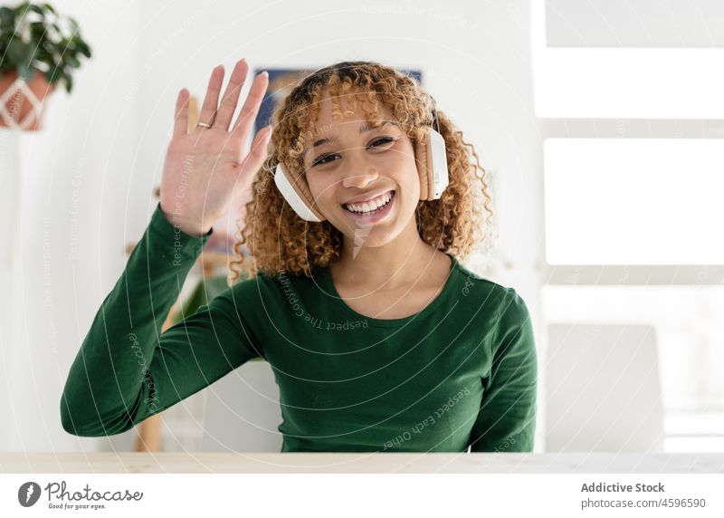 Positive smiling ethnic woman demonstrating saluting sign video call greeting hello gesture show demonstrate cheerful salute positive happy symbol afro