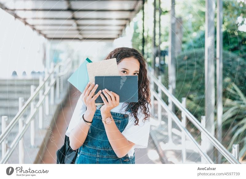 University entry Portrait of a Smart Beautiful arab Girl Holding Study Text Books Smiling Looking at the Camera. Authentic Student has a lot to study and read, for Class Assignment, Exams Preparation