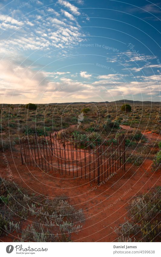 Abandoned Cemetery in the Desert. Grave Deserted Outback Derelict Fence Rustic Landscape vegetation Sky Clouds lonely alone Historic Pioneer Death Exterior shot