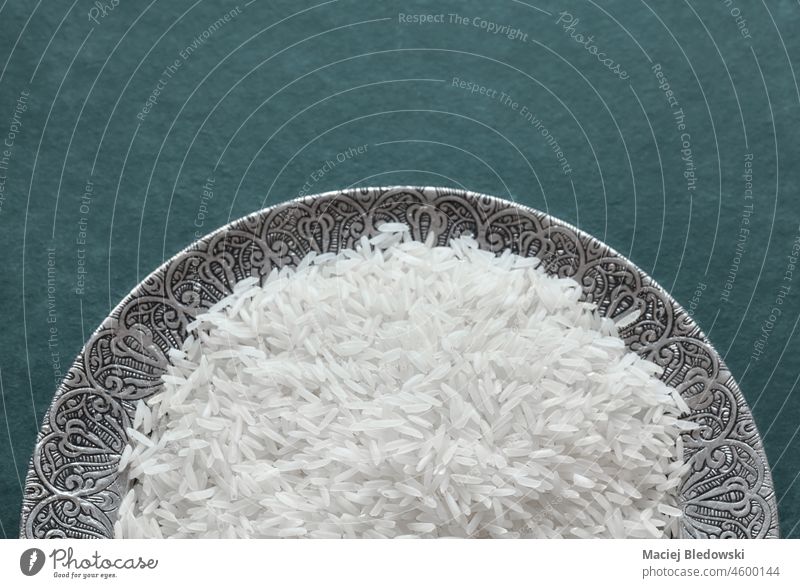 Close up picture of basmati rice on a silver plate, selective focus. close up raw nutrition food white healthy asian vegetarian grain uncooked organic natural