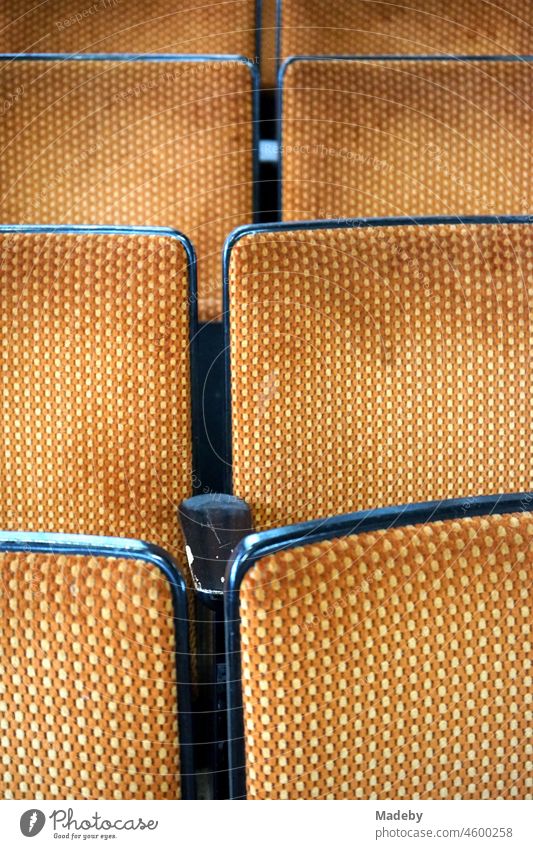 Old cinema chairs as cinema seating with fabric cover in the style and colors of the seventies in an old factory hall with antiques in the district Margaretenhütte in Giessen on the Lahn in Hesse