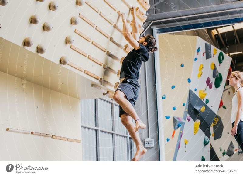 Man practicing rock climbing in gym man wall sport training alpinism sporty climbing wall exercise practice hobby activity male wellness active activewear