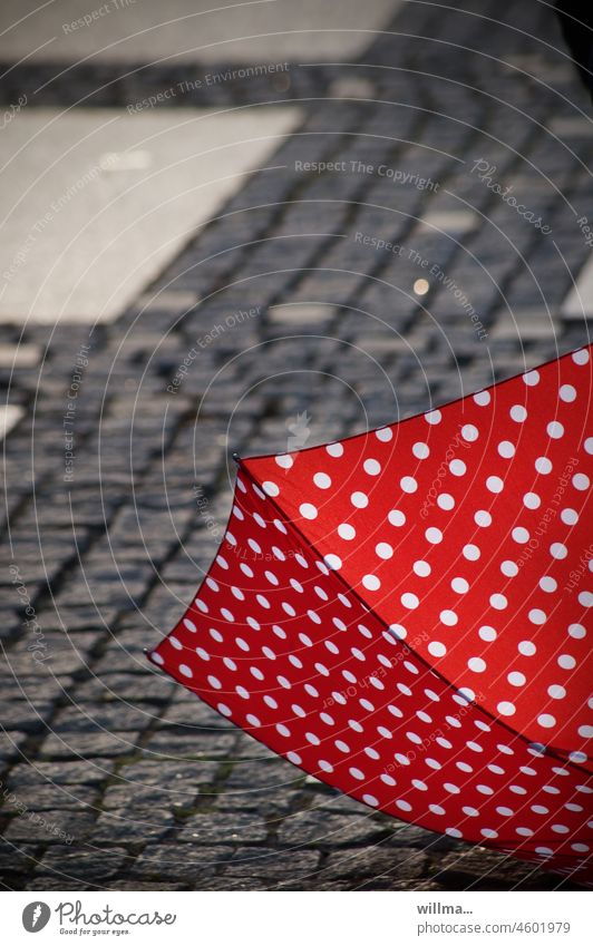 Cover of the new psychological thriller 'Parachute and Vanishing Point' Umbrellas & Shades Red white dots Spotted Exterior shot Colour photo Paving stone