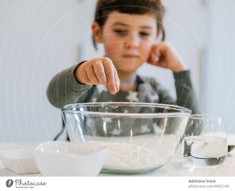 Girl preparing flour for pastry girl kitchen cook culinary kid ingredient home domestic child helper prepare bowl apron food glass water utensil recipe