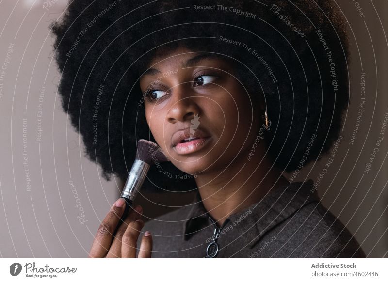 Black woman recording beauty video makeup tutorial cosmetic vlog smartphone ring lamp powder blog social media online afro leisure hairstyle feminine blogger