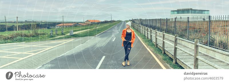 View from inside camper van of woman posing on the road young travel landscape banner web header panorama panoramic background copy space looking aside