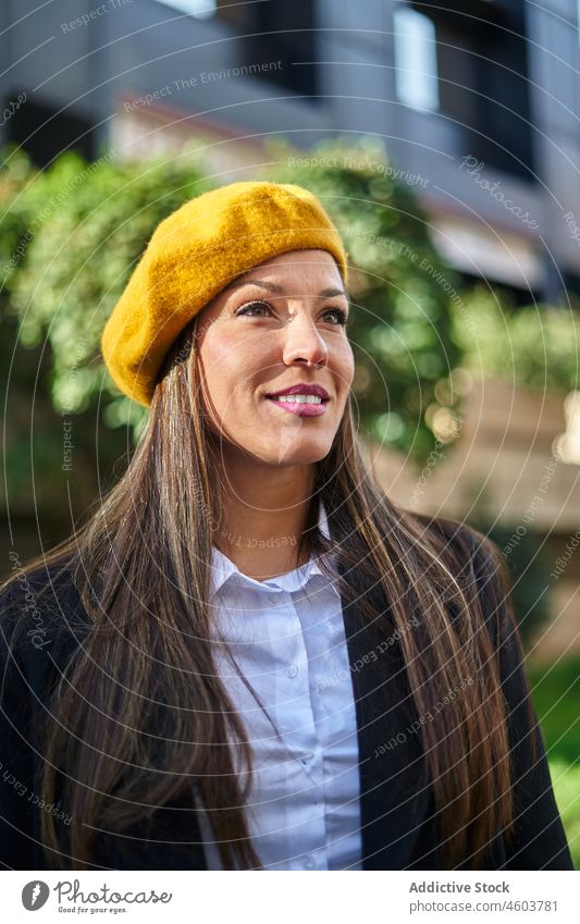 Positive businesswoman in stylish beret on street entrepreneur city style portrait feminine fashion respectable urban building female elegant positive attire