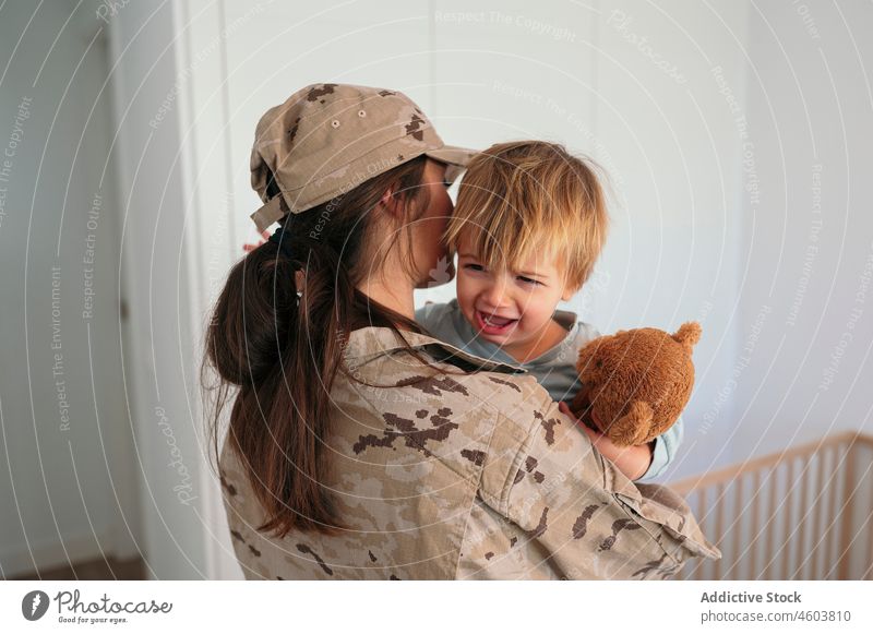 Faceless military woman consoling crying child mother son soldier army duty boy motherhood console hug upset patriot cute love bed together childcare childhood