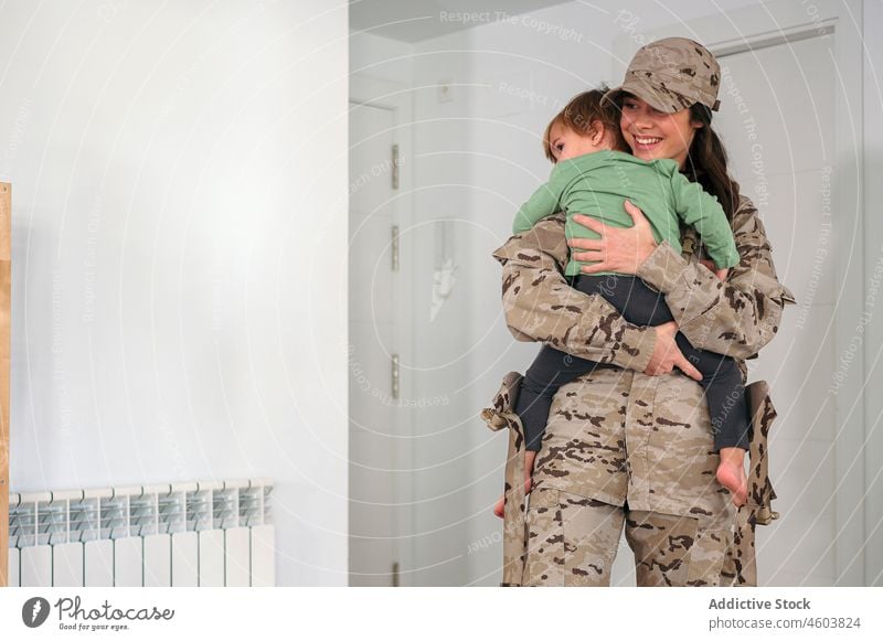 Military woman carrying faceless son mother military soldier army duty boy motherhood patriot bonding child cute love together childcare childhood home uniform