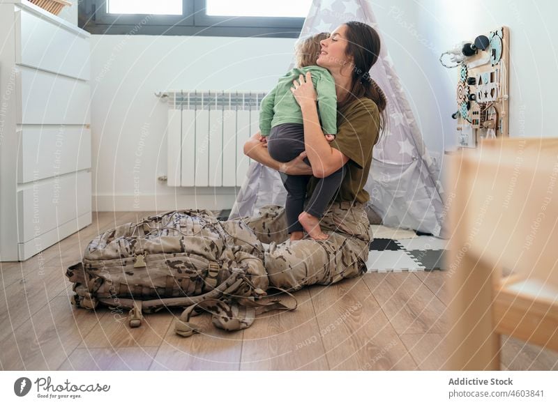Military woman hugging faceless son mother military soldier duty boy arrive caress motherhood playroom patriot child cute love service together childcare