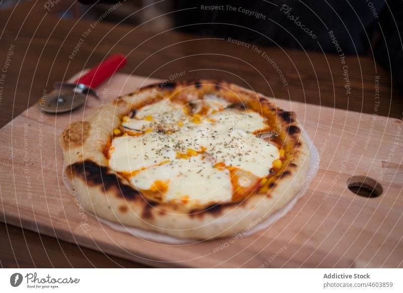 Hot baked pizza with mozzarella cheese steam italian cuisine homemade culinary meal food serve tasty delicious cutting board kitchen hot crispy sauce appetizing