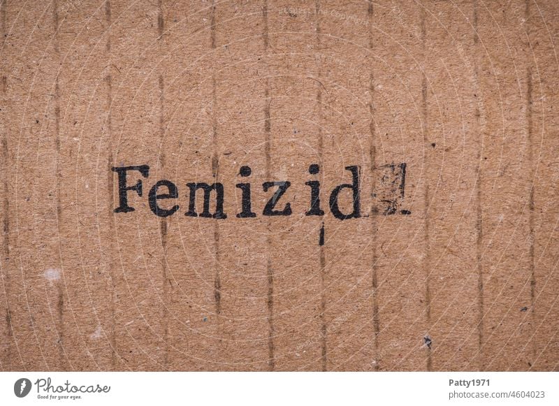 Stamped text on cardboard. Femicide femicide misogyny Sexism Woman felonies Murder Hatred equal rights Cardboard paperboard Paper Old Grunge Brown Text