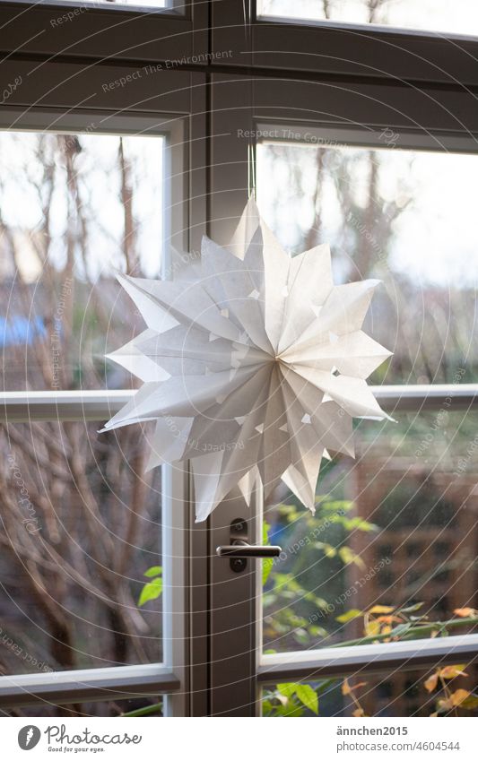 white star made from sandwich bags hangs on a white old transom window Stars Window Light Christmas & Advent Christmas decoration Star (Symbol) Decoration