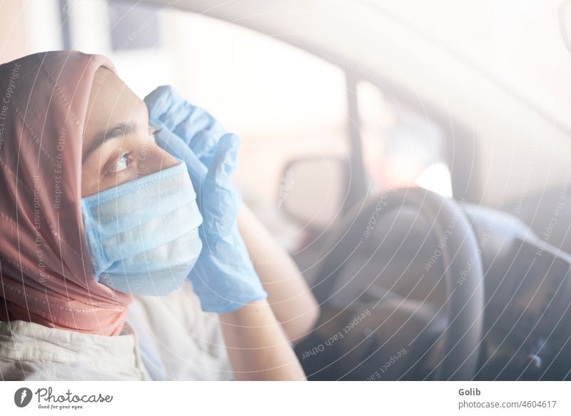 Muslim woman in face mask and gloves driving car coronavirus pandemic young muslim surgical female doctor hijab protective gear go to work go out buy