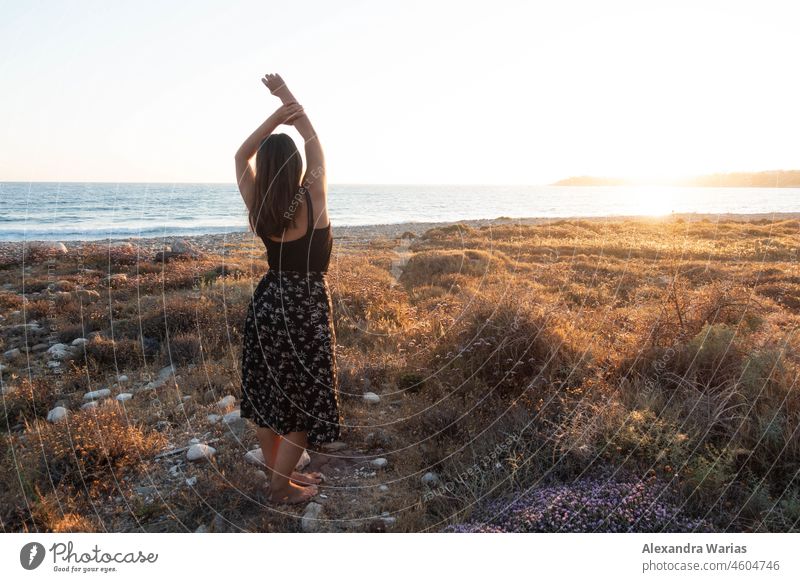 Woman with long hair in dress by the sea at sunset in Cyprus Woman's body Dress Ocean Sunset sunset mood Seashore seaboard Sunset light Sunset sea Europe