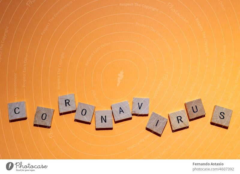 Coronavirus. Covid-19 written with letters. Orange background and space for text. Horizontal photography. coronavirus illness epidemic pandemic medical vaccine